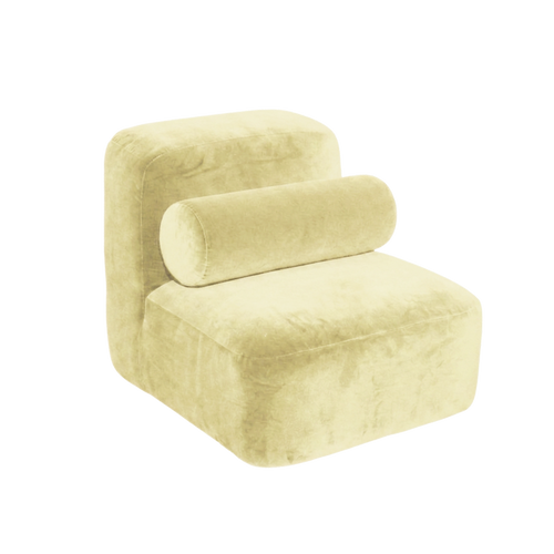 A modern low-profile accent chair upholstered in a soft, textured light yellow fabric, featuring a cylindrical lumbar pillow, isolated on a white background.